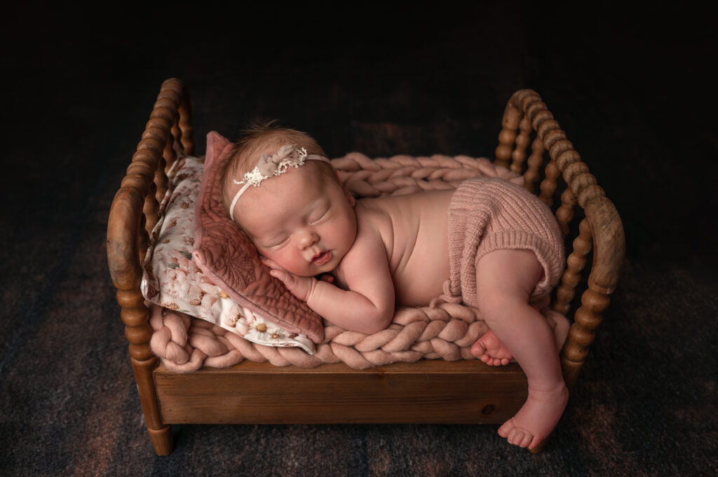 Newborns posed in beds