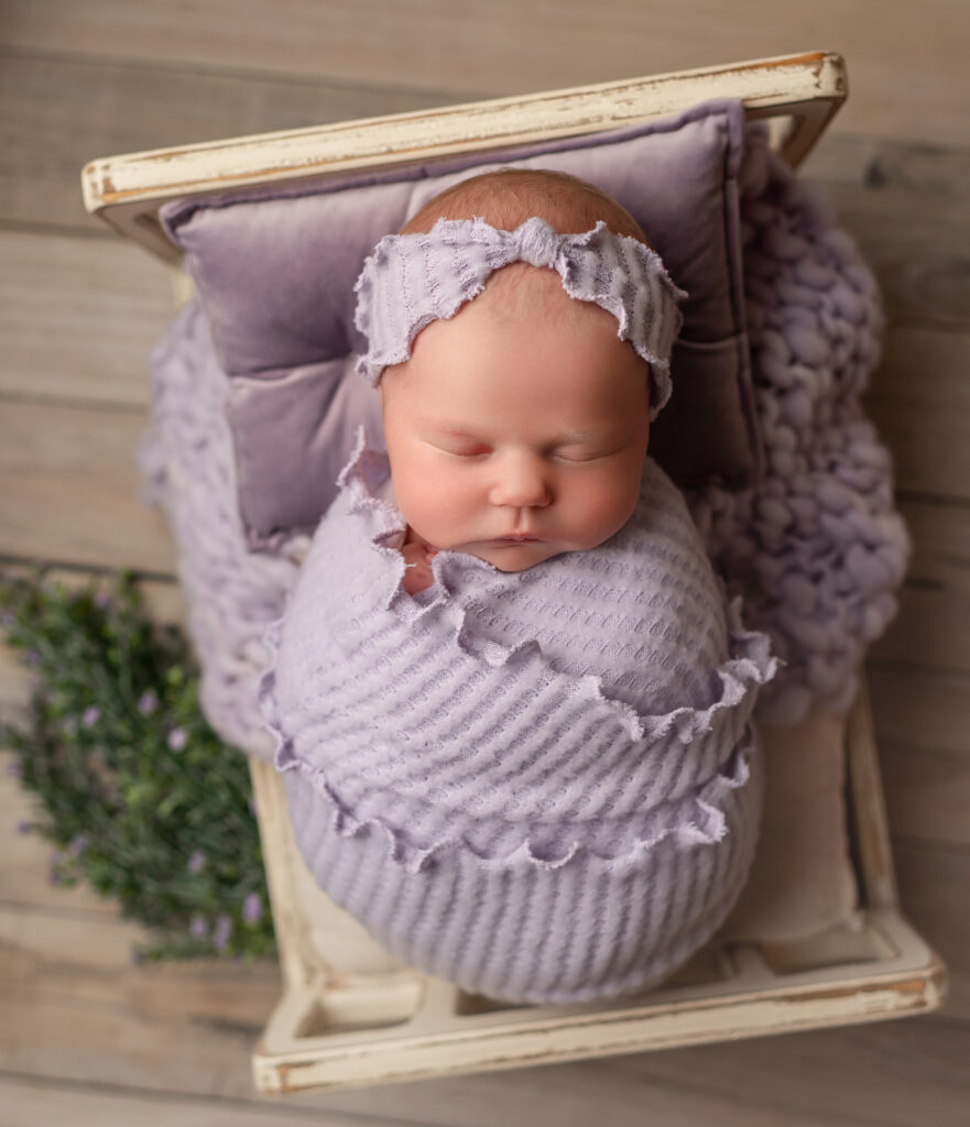 Newborn in purple outfit